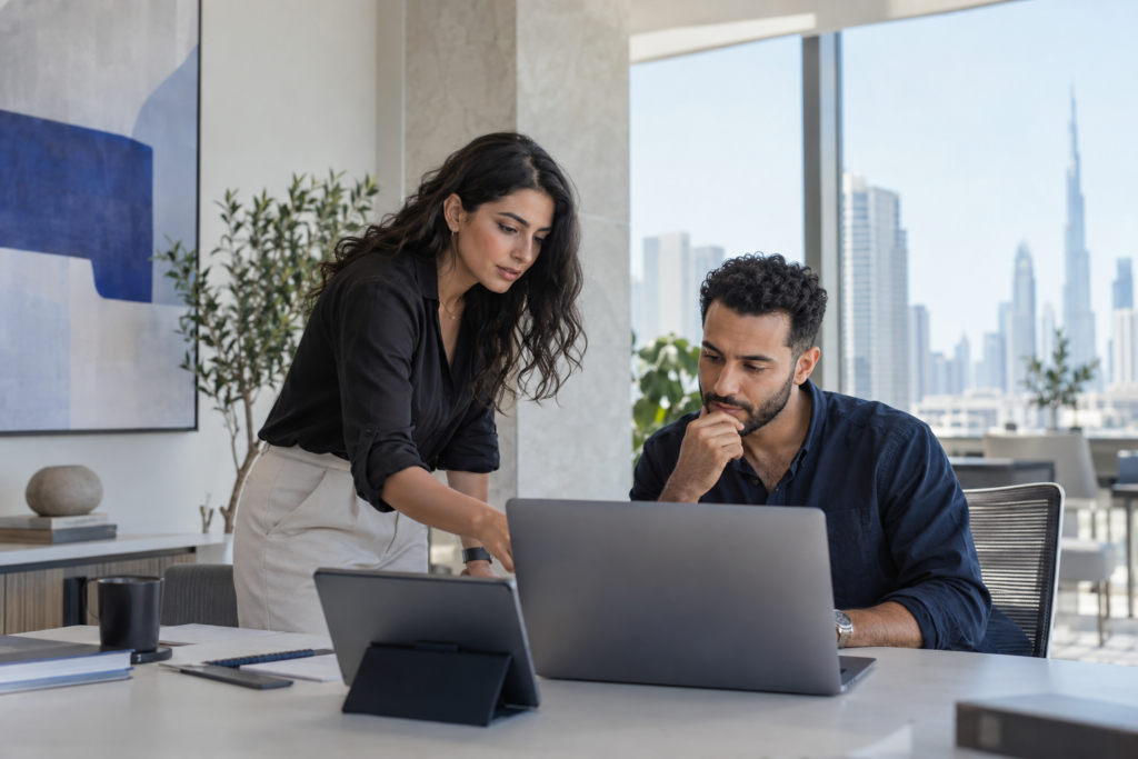 Illustrative image of two technology consultants reviewing a project together